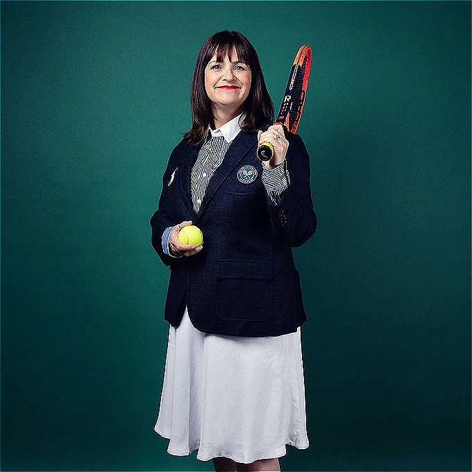 Female comedian, former wimbledon line judge holding a racquet and tennis ball