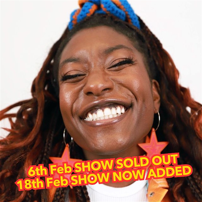 Sophie Duker smiles extremely broadly at the camera