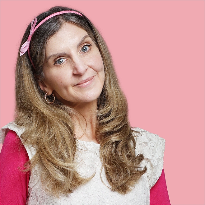 Female comedian smiling and looking innocent...But is she?