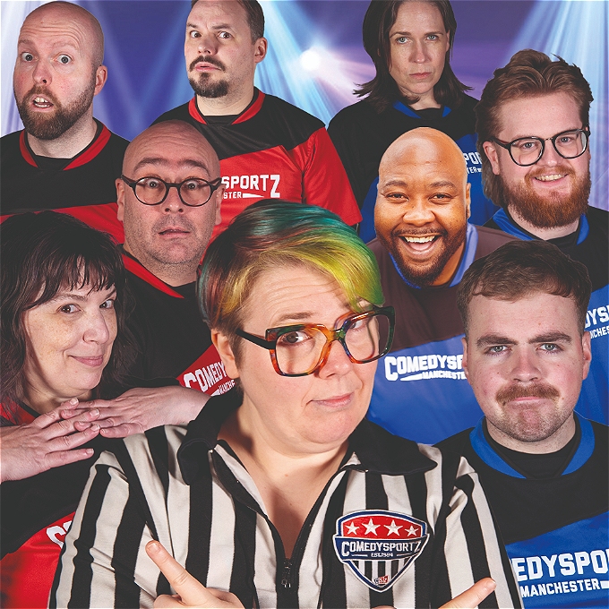 The referee points at players of the red and blue teams to determine who will win the ComedySportz match. Players are pulling a mix of smiling, game and silly faces. Due to poor photoshop skills the scales of the players faces are all slightly off.