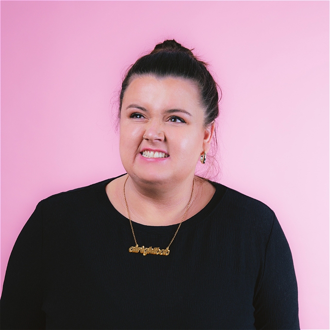 Female comic with brown messy hair looking exasperated over a pink background