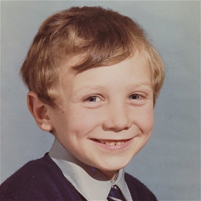 Smiling young boy's school photo headshot