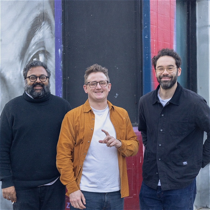Three smiling podcasts outside The Bill Murray pub