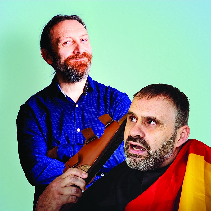 Two male comedians positioned as though they are talking to each other