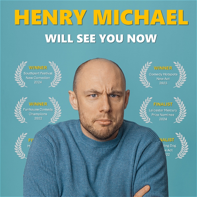 Male comedian with arms crossed, looks tired, effectively a young face embodied in an old man's head