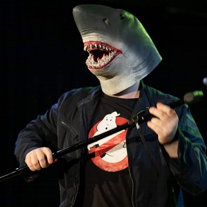 shark dancing with a walking stick wearing a ghostbusters t-shirt