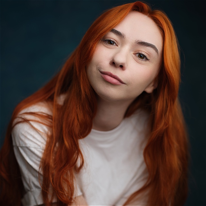 Female comedian with red hair and a white tshirt