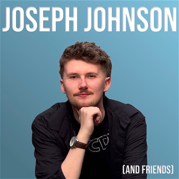 Male comedian in front of blue background