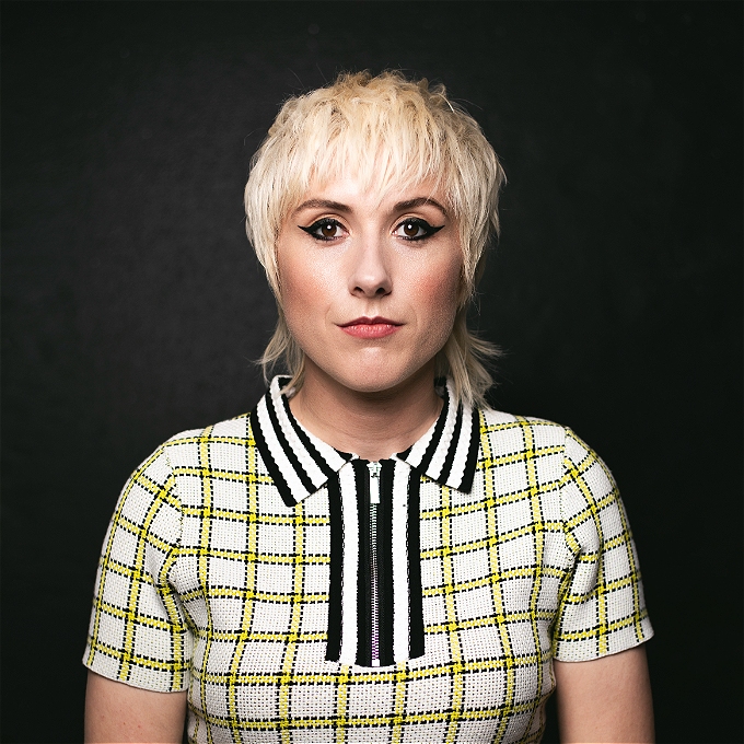 Maisie Adam looks intently at the camera