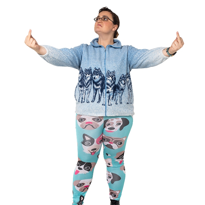 Female comedian with brown hair in dog print leggings and wolf fleece