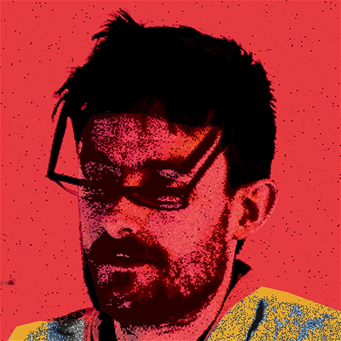 Nate Kitch the comic with his eyes closed and his glasses tilted