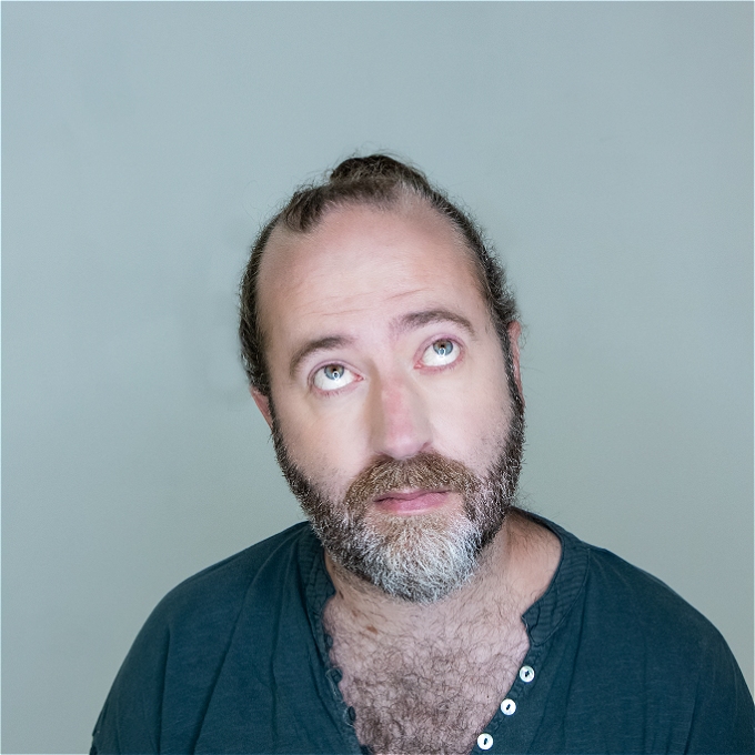 Male comedian looking up.