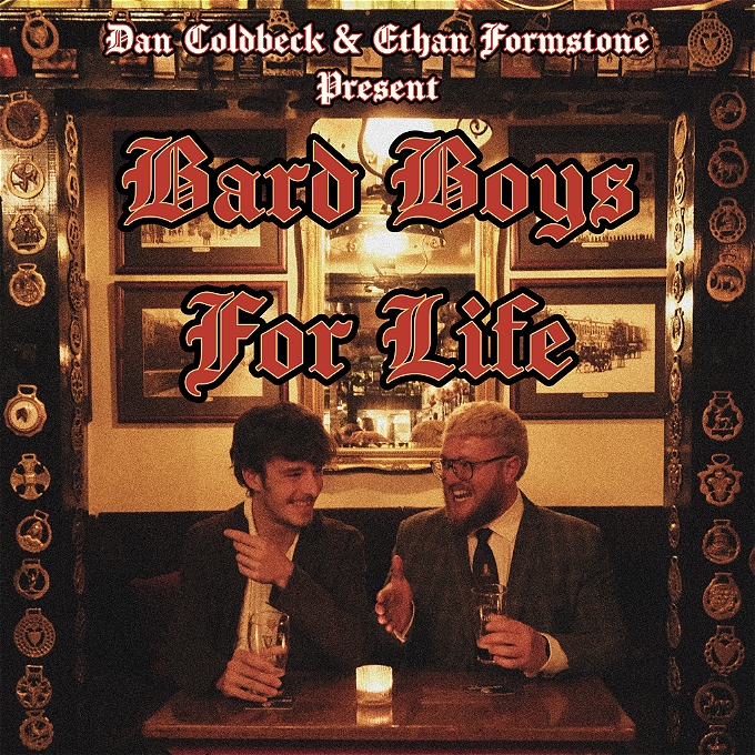 Two men sat at a table in a pub talking to eachother