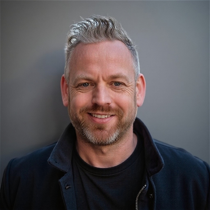 Comedian Mark Row wearing a blue jacket and not looking enough like a loser to fit with the show title!