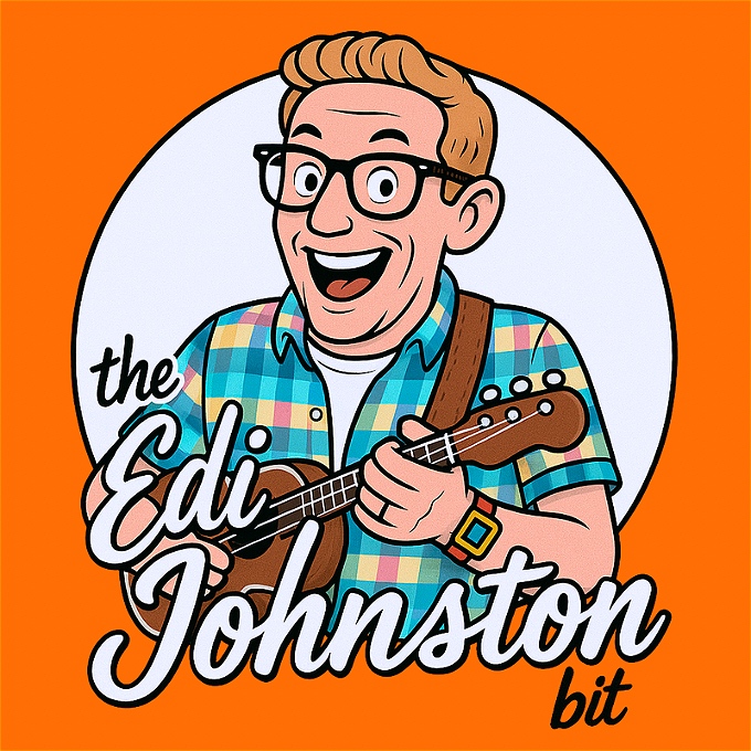 Male Ginger Haired Musical Comedian with glasses on smiling and playing a ukulele