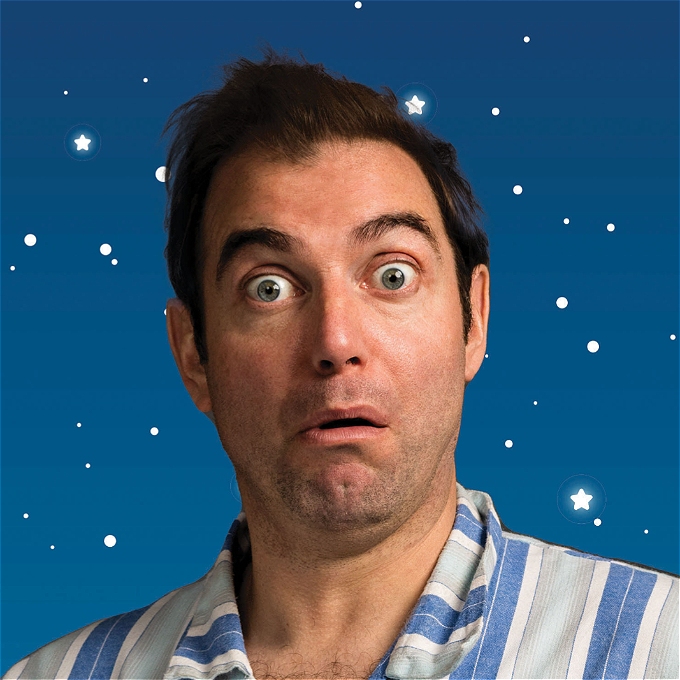 Male comedian wearing stripey pyjamas