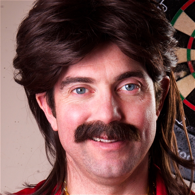 a man with a moustache smirking