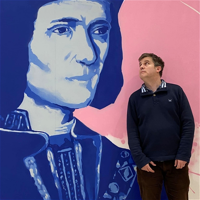 Richard pictured with a mural of Richard II in the High Cross Shopping Centre in Leicester