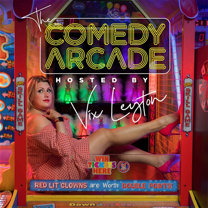 Woman sits inside a penny arcade machine with a clown coconut shy