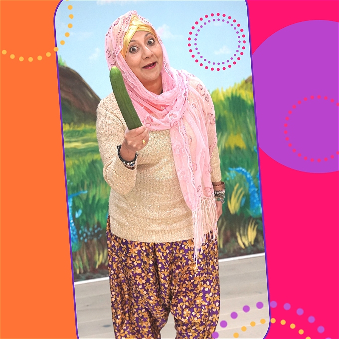 Female Comedian holding a cucumber