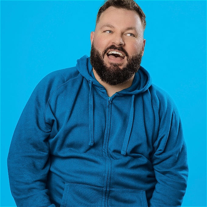 Happy bearded man looking to the side.