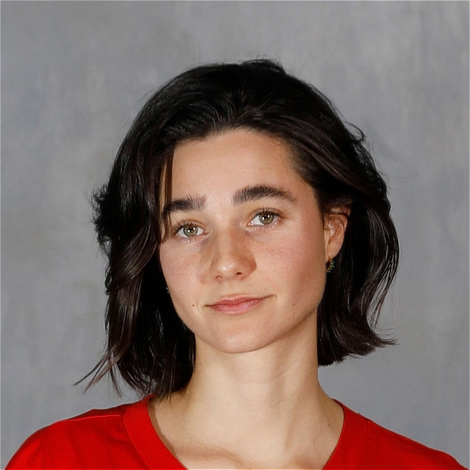 Lara Ricote looks at the camera with a neutral expression