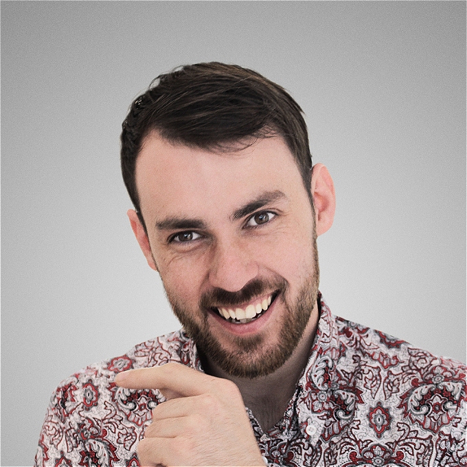 Alex Hylton smiling into the camera, in the red shirt he usually wears at gigs. God he's handsome.