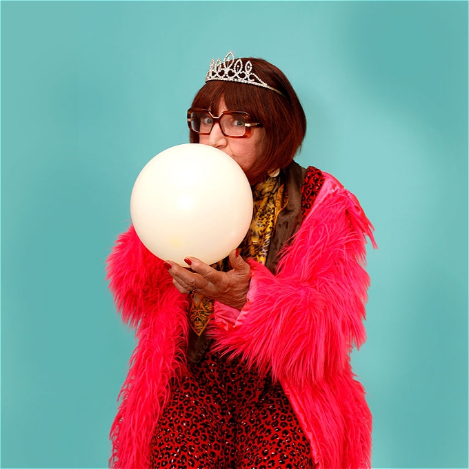 A smiling Kevin Daniel holding the winner's trophy at the 2024 Silver Stand Up competition.