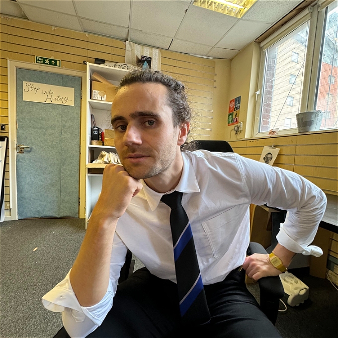 Comedian holding a bb gun to his heaf