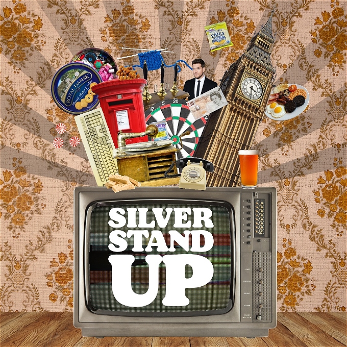 A smiling Kevin Daniel holding the winner's trophy at the 2024 Silver Stand Up competition.