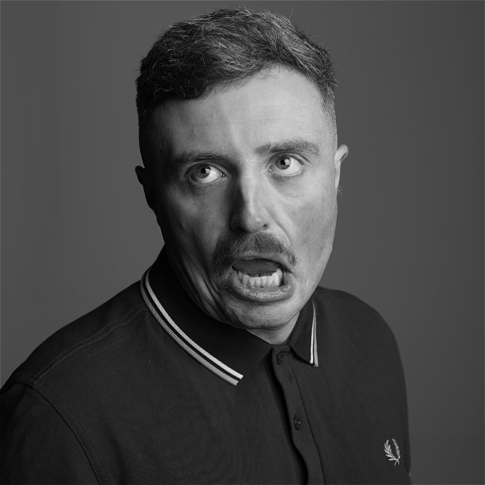 Male comic pulling funny faces