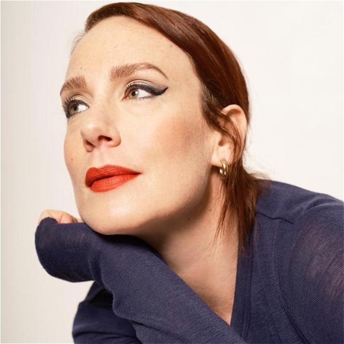 A smouldering Sara Barron looks away off camera